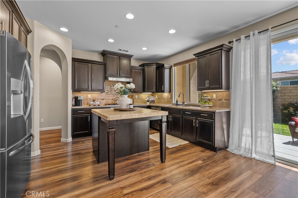 28640 Farrier Drive Valencia, CA 91354 - Photo 11 of 67 a kitchen with stainless steel appliances granite countertop a refrigerator stove top oven and sink