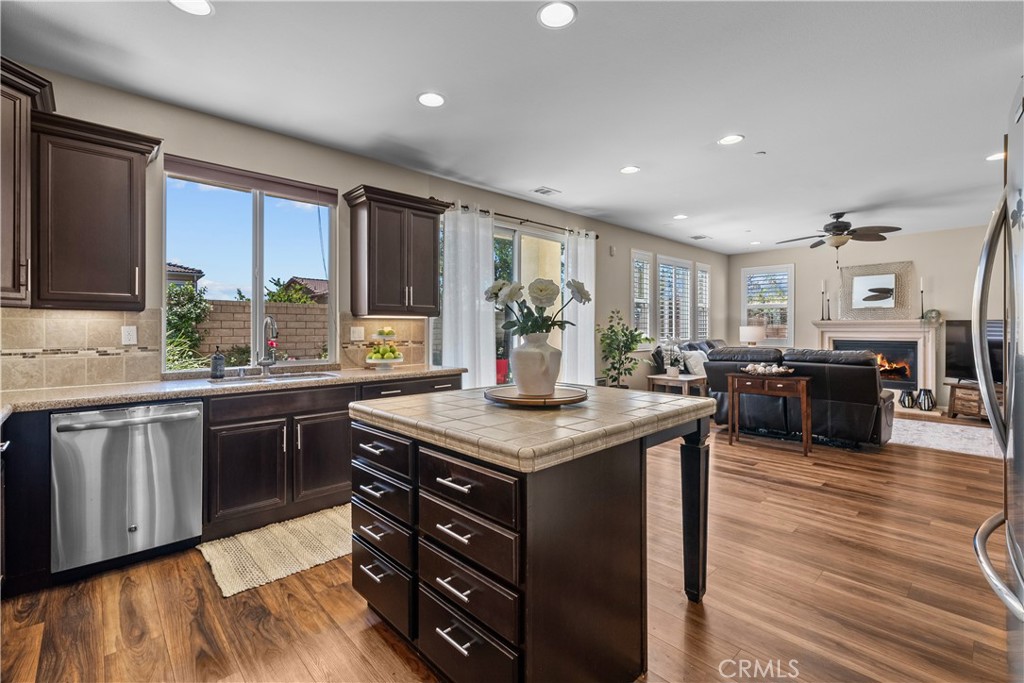 28640 Farrier Drive Valencia, CA 91354 - Photo 12 of 67 a kitchen with stainless steel appliances granite countertop wooden cabinets a sink dishwasher a stove and a refrigerator with wooden floor