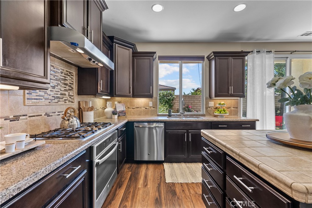 28640 Farrier Drive Valencia, CA 91354 - Photo 14 of 67 a kitchen with stainless steel appliances granite countertop sink stove and cabinets