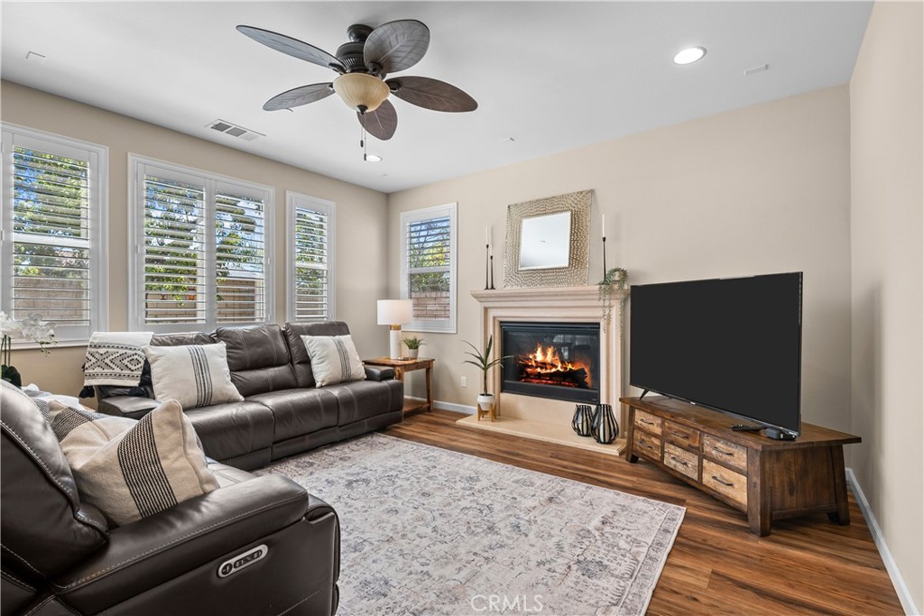28640 Farrier Drive Valencia, CA 91354 - Photo 17 of 67 a living room with furniture a flat screen tv and a fireplace
