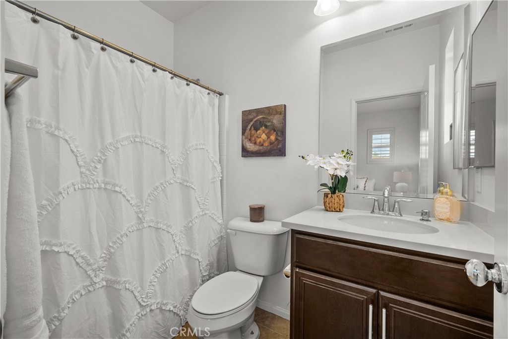 28640 Farrier Drive Valencia, CA 91354 - Photo 33 of 67 a bathroom with a granite countertop sink and a toilet