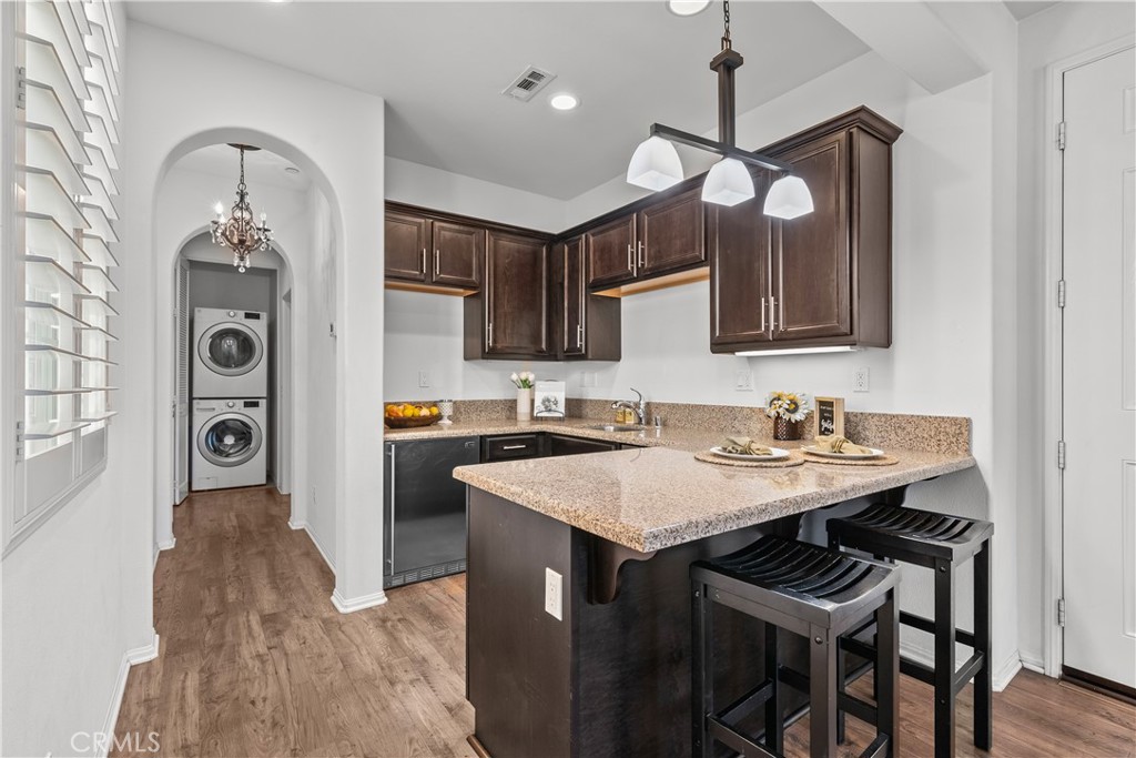 28640 Farrier Drive Valencia, CA 91354 - Photo 38 of 67 a kitchen with a sink dishwasher a stove a microwave oven with a dining table and chairs
