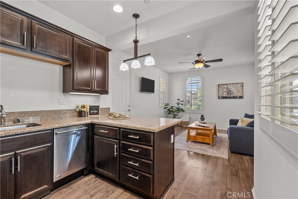 28640 Farrier Drive Valencia, CA 91354 - Photo 39 of 67 a kitchen with stainless steel appliances granite countertop a sink dishwasher stove and refrigerator with wooden floor