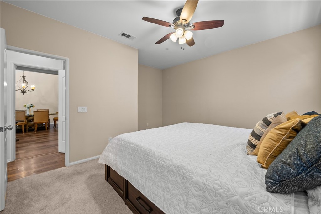 28640 Farrier Drive Valencia, CA 91354 - Photo 43 of 67 a bedroom with a bed and a chandelier