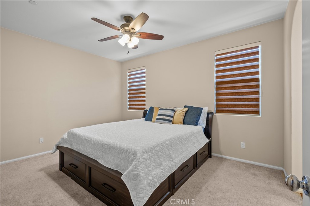 28640 Farrier Drive Valencia, CA 91354 - Photo 45 of 67 a bedroom with a bed and a chandelier