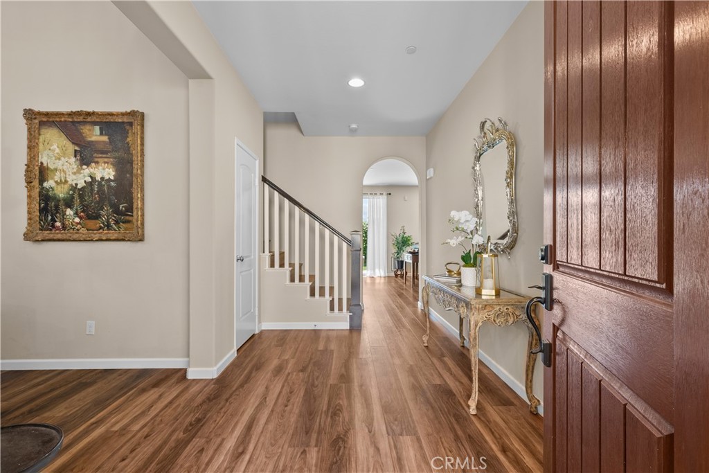 28640 Farrier Drive Valencia, CA 91354 - Photo 5 of 67 a view of a hallway with wooden floor and stairs