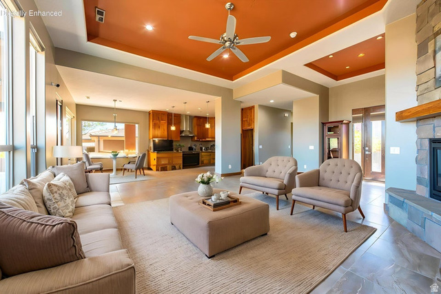 322 340 E Street Ivins, UT 84738 - Photo 11 of 61 Spacious open-concept living area featuring a stone fireplace with a wood mantle, large floor-to-ceiling windows, and recessed ceiling lighting