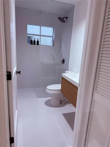 a bathroom with a toilet and a shower