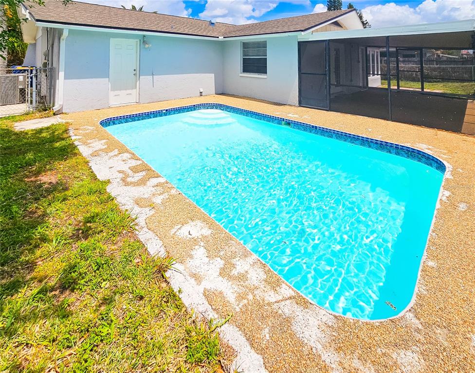 7304 Embassy Boulevard Port Richey, FL 34668 - Photo 2 of 14 a swimming pool with an outdoor space