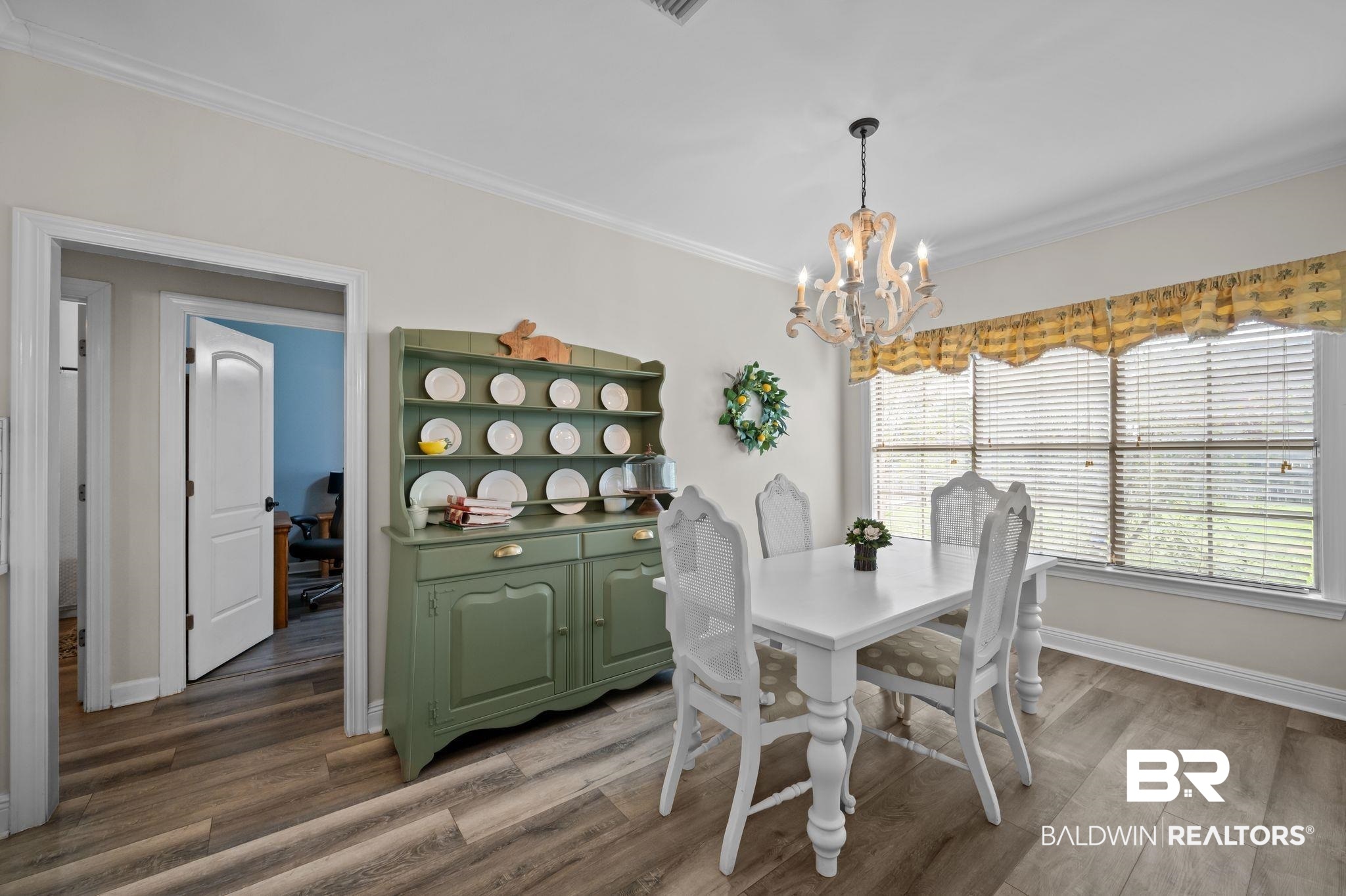 9837 Harmony Ridge Drive Semmes, AL 36575 - Photo 12 of 29 Dining area featuring baseboards, ornamental molding, wood finished floors, and a chandelier