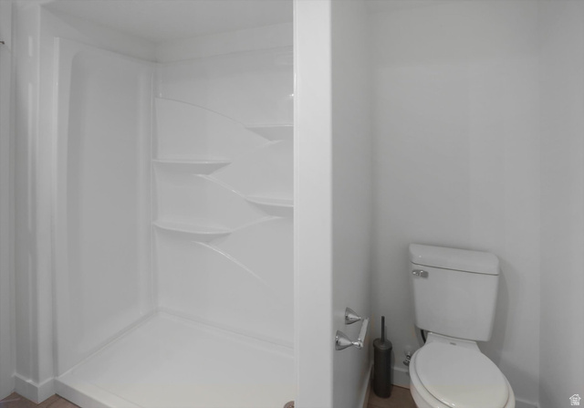 3636 West 910 South Syracuse, UT 84075 - Photo 22 of 70 White shower stall with integrated shelving and a white ceramic toilet