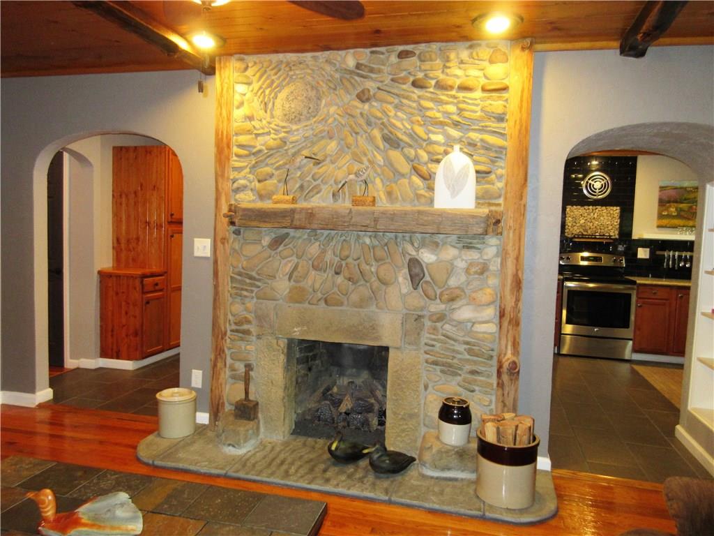 446 Baileys Run Road Tarentum, PA 15084 - Photo 4 of 25 Beautiful stone gas burning fireplace with barn beam mantle, B board ceiling with honed Hemlock beams, recessed lighting, gleaming hardwood floors.