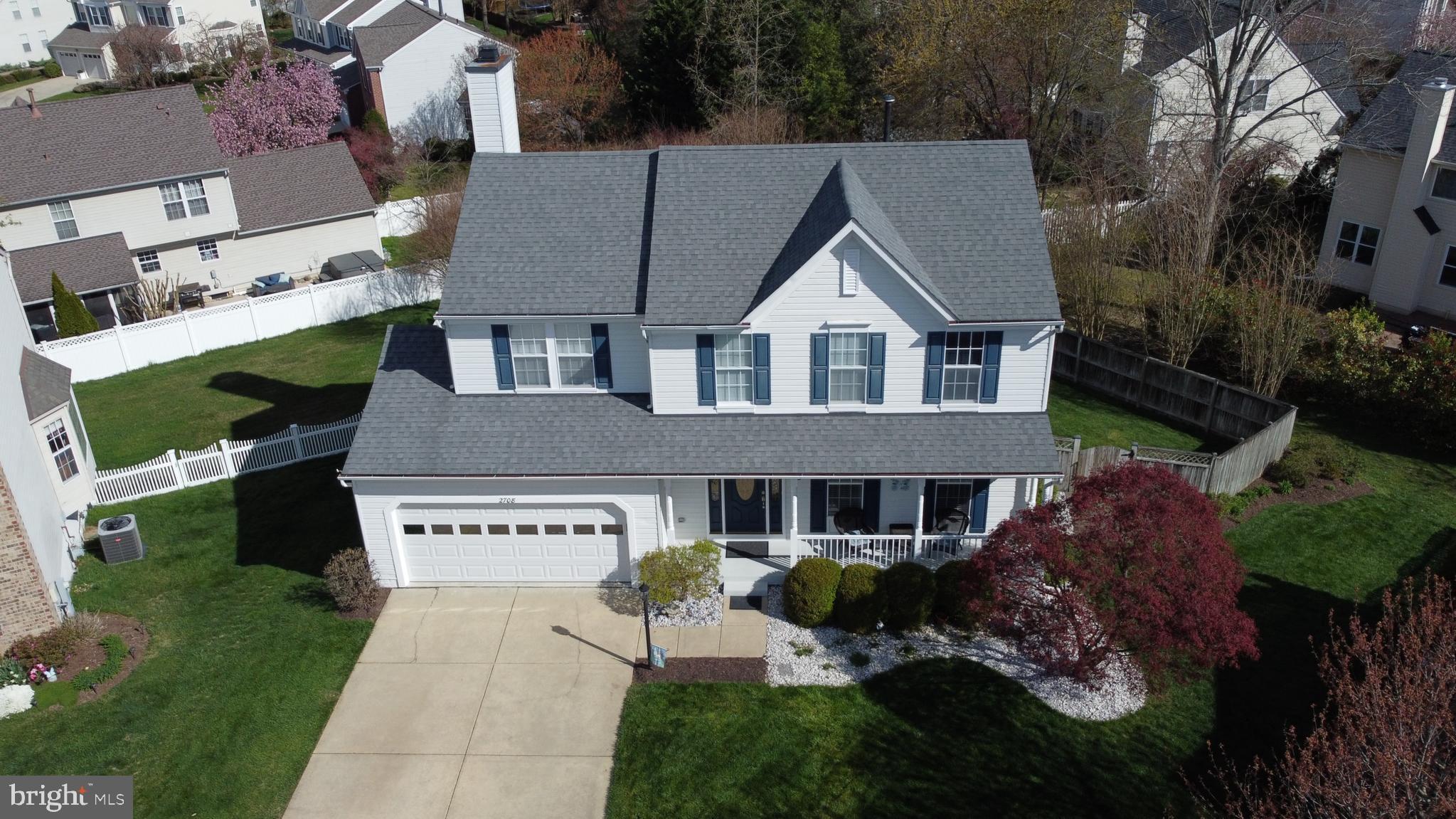 2708 Strongs Court Crofton, MD 21114 - Photo 2 of 7 a front view of a house with a garden and trees