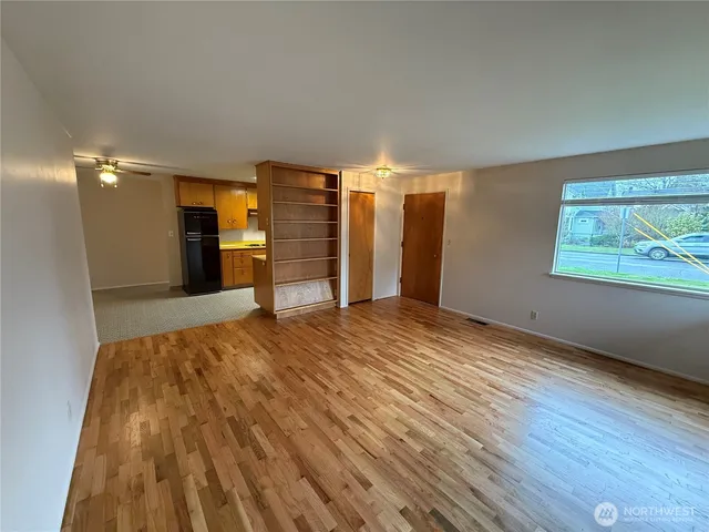 wooden floor in an empty room with a window