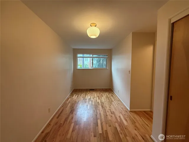 a view of wooden floor and a chandelier in a room
