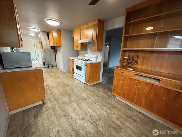 a kitchen with a refrigerator and a stove top oven