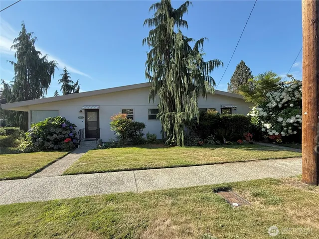a white house with palm trees in front of it