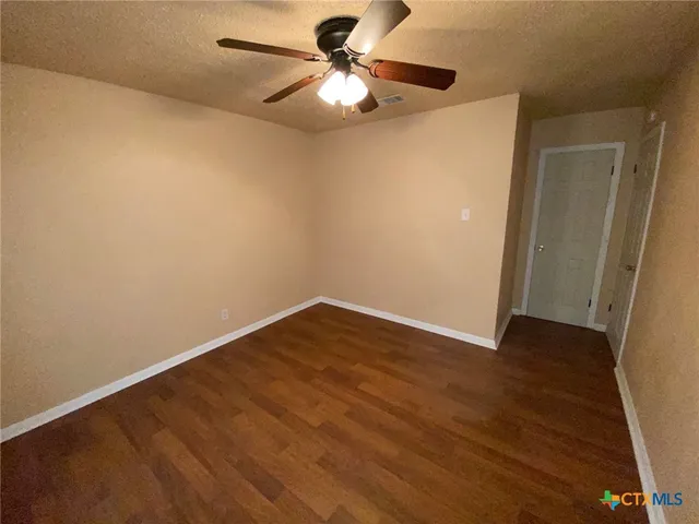 a view of an empty room with a fan