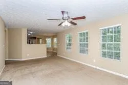 a view of a livingroom with a ceiling fan and window