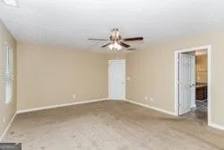 a view of a room with a ceiling fan and a window