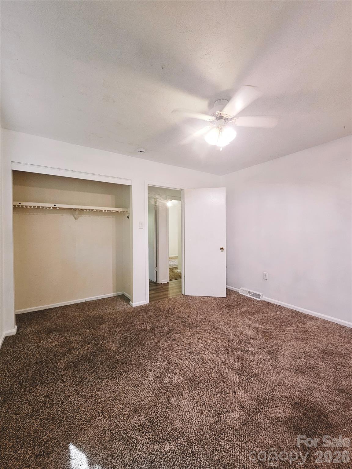 468 Beaverdam Road Asheville, NC 28804 - Photo 18 of 19 an empty room with closet and a ceiling fan