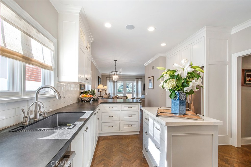213 Via Firenze Newport Beach, CA 92663 - Photo 11 of 41 a kitchen with a sink stove and cabinets