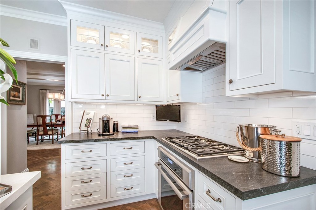213 Via Firenze Newport Beach, CA 92663 - Photo 13 of 41 a kitchen with granite countertop a stove a sink and a white cabinets