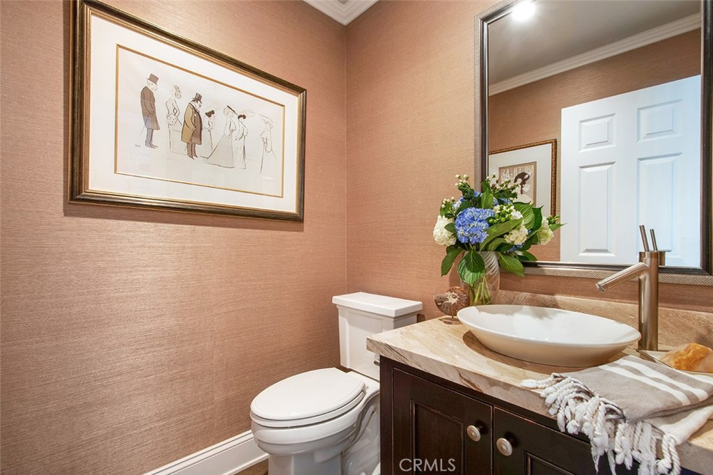 213 Via Firenze Newport Beach, CA 92663 - Photo 23 of 41 a bathroom with a toilet sink and mirror