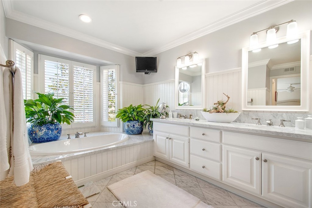 213 Via Firenze Newport Beach, CA 92663 - Photo 27 of 41 a spacious bathroom with a tub sink and mirror