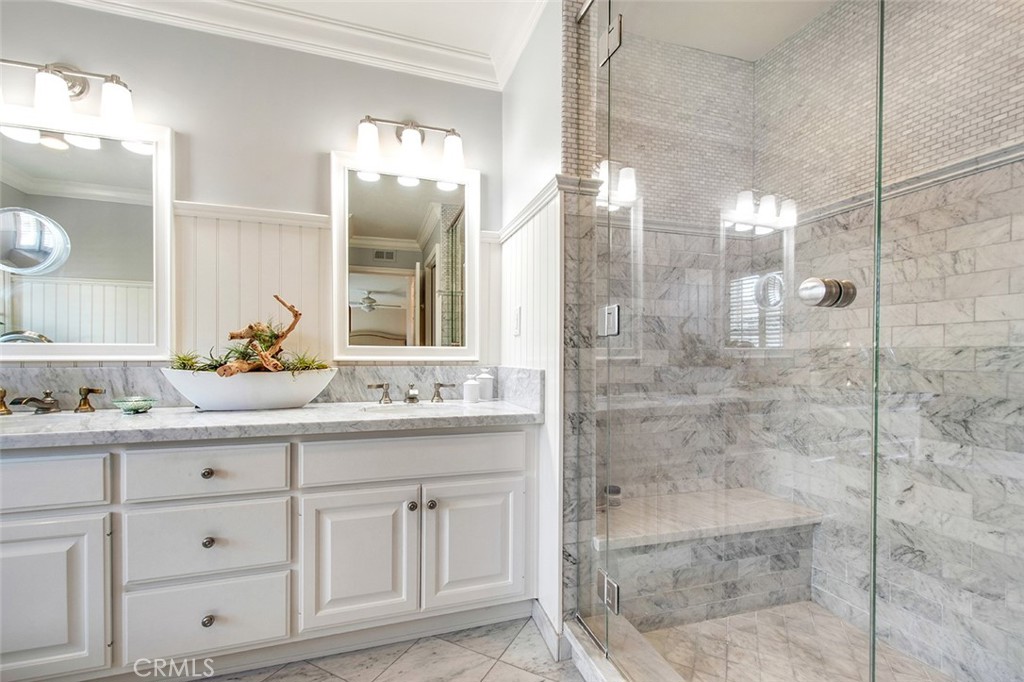 213 Via Firenze Newport Beach, CA 92663 - Photo 28 of 41 a bathroom with a shower sink and mirror