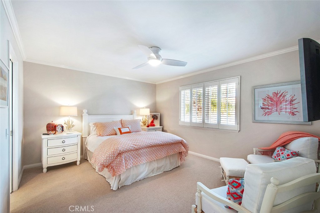 213 Via Firenze Newport Beach, CA 92663 - Photo 31 of 41 a bedroom with a bed and a chandelier