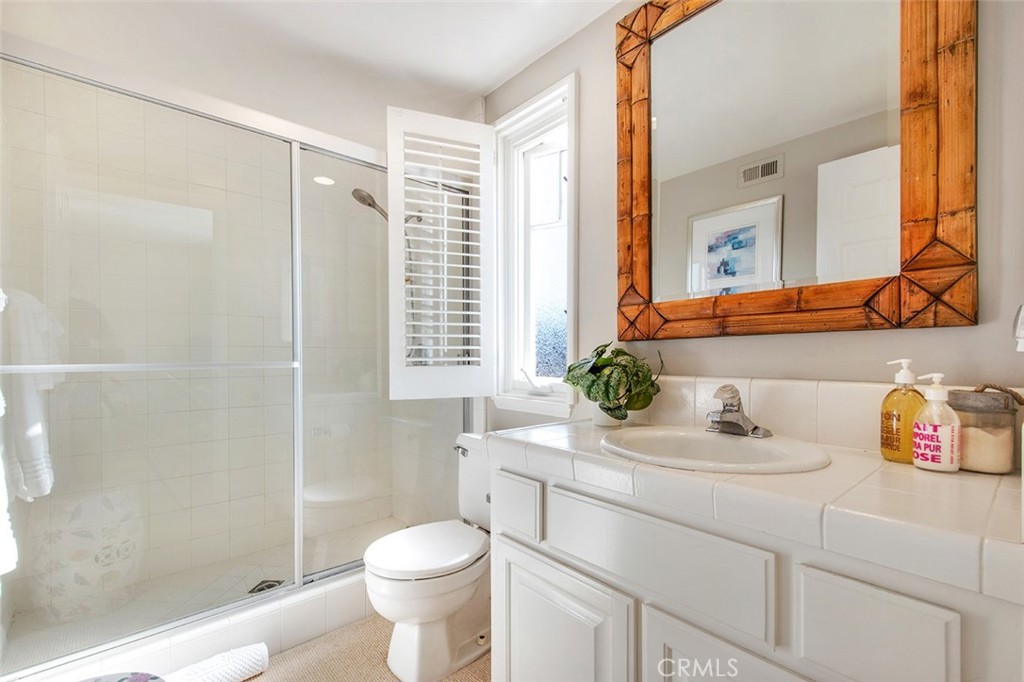 213 Via Firenze Newport Beach, CA 92663 - Photo 32 of 41 a bathroom with a sink toilet vanity and shower