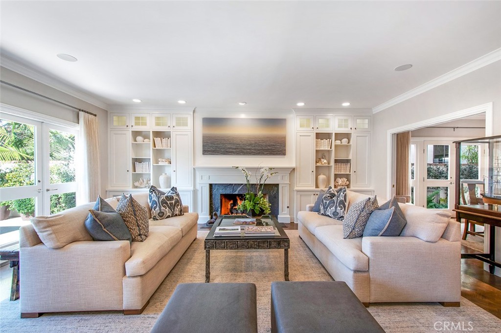 213 Via Firenze Newport Beach, CA 92663 - Photo 4 of 41 a living room with fireplace furniture and a large window