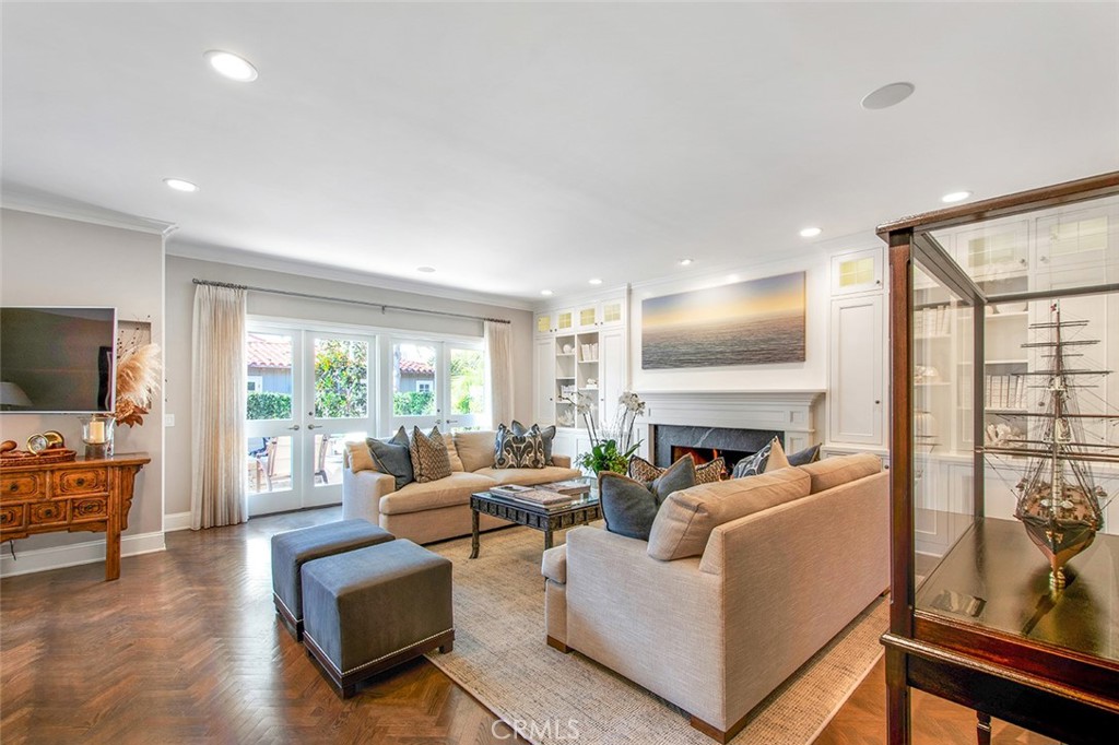 213 Via Firenze Newport Beach, CA 92663 - Photo 6 of 41 a living room with furniture floor to ceiling window hardwood floor and a flat screen tv