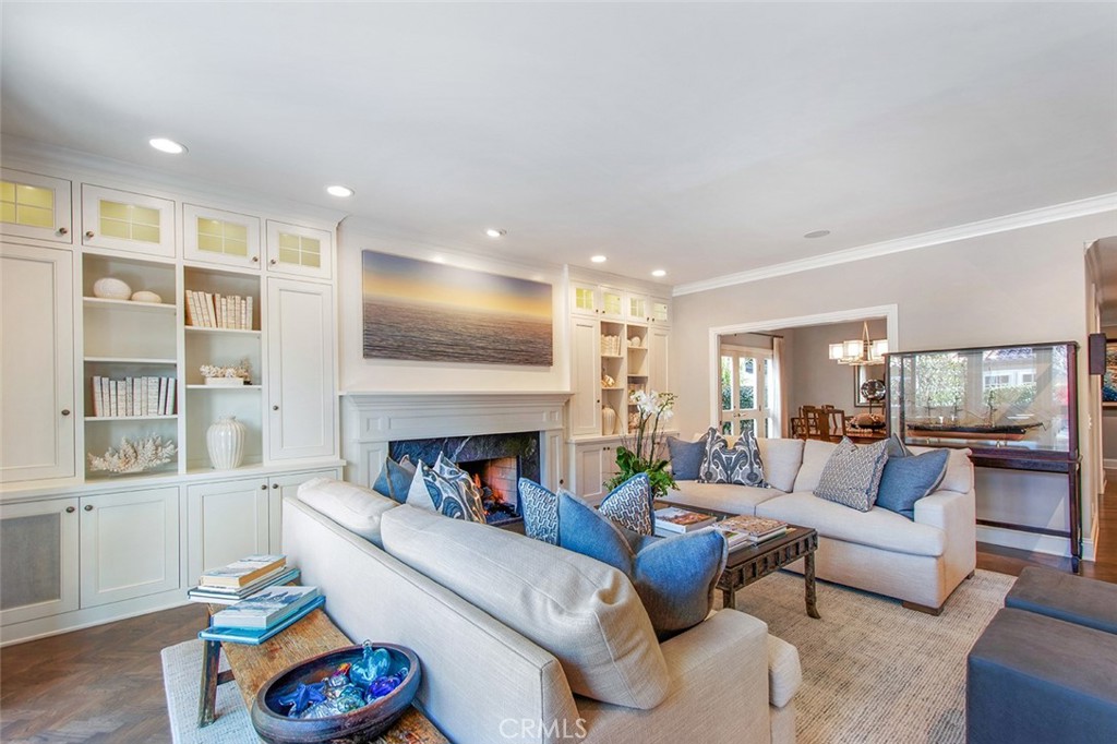 213 Via Firenze Newport Beach, CA 92663 - Photo 8 of 41 a living room with furniture and a fireplace