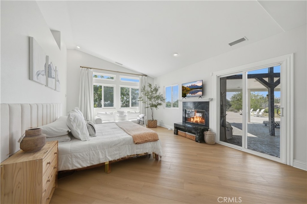 41110 Los Ranchos Circle Temecula, CA 92592 - Photo 26 of 77 a bedroom with furniture and a fireplace