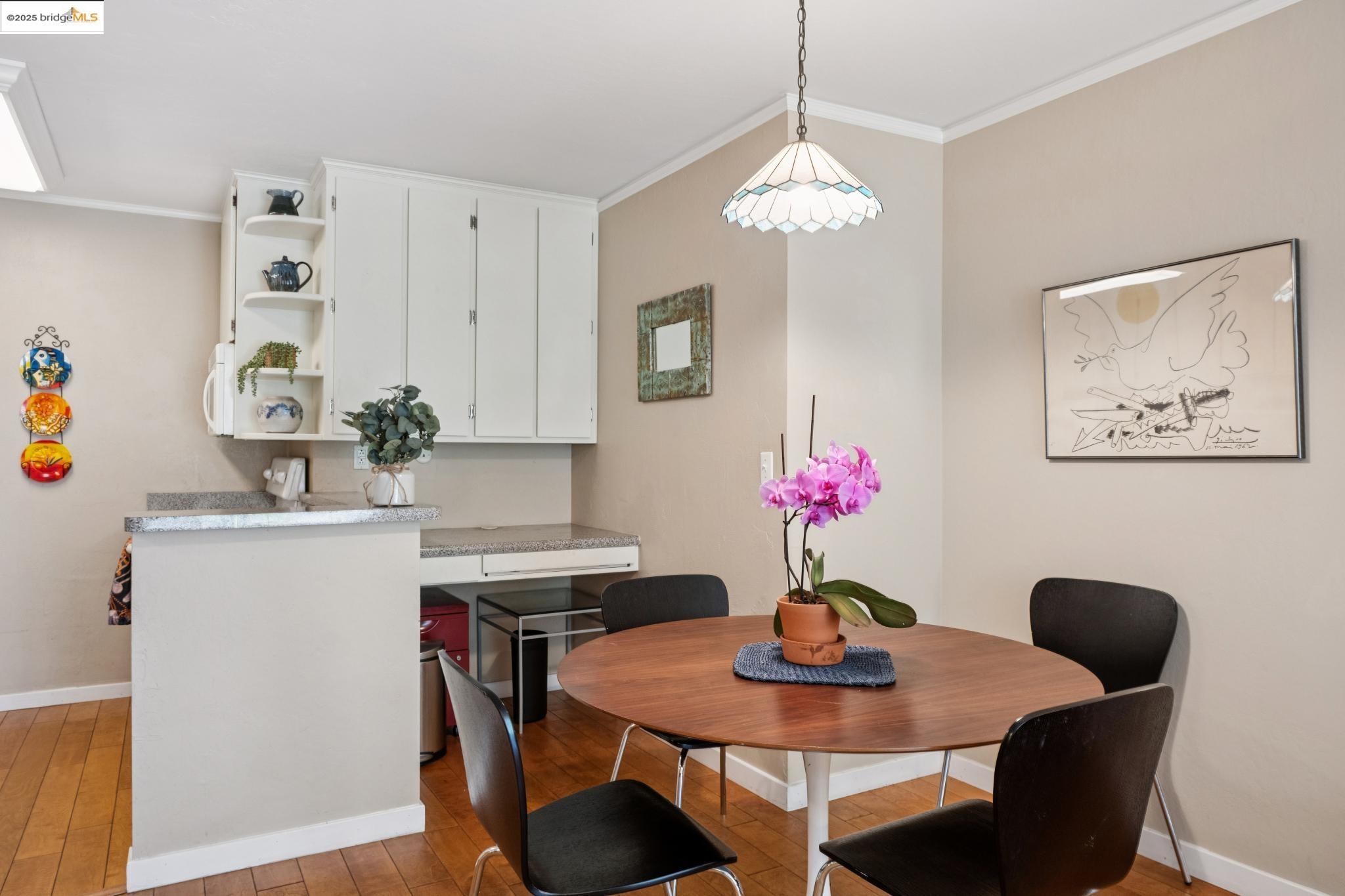 250 Whitmore Street Oakland, CA 94611 - Photo 15 of 33 Dining area with crown molding and light wood-style flooring