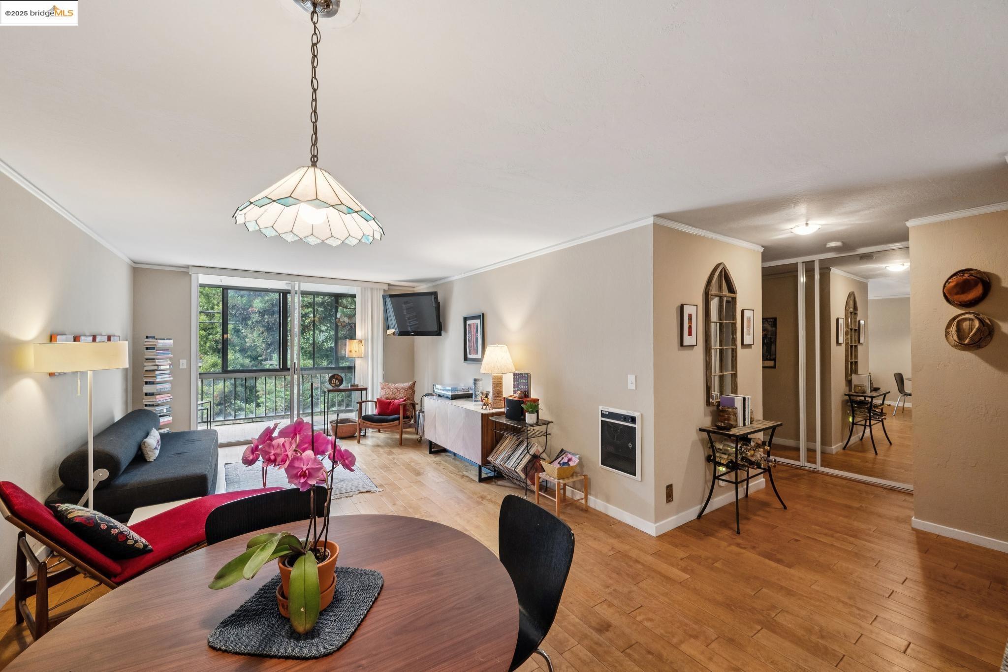 250 Whitmore Street Oakland, CA 94611 - Photo 16 of 33 Dining space with floor to ceiling windows, ornamental molding, light wood-style flooring, and heating unit