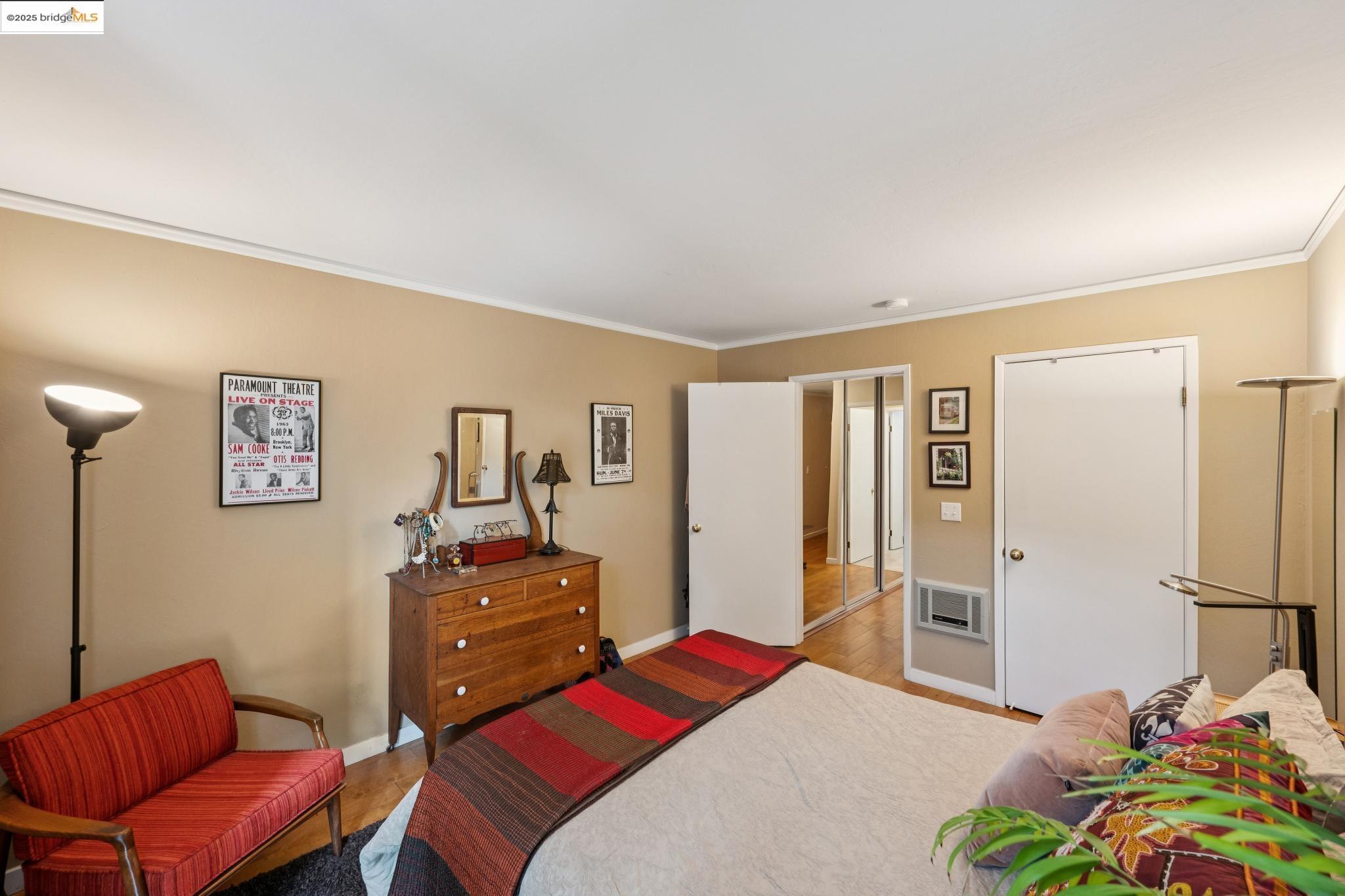 250 Whitmore Street Oakland, CA 94611 - Photo 24 of 33 Bedroom with crown molding, light wood-type flooring, a closet, and heating unit