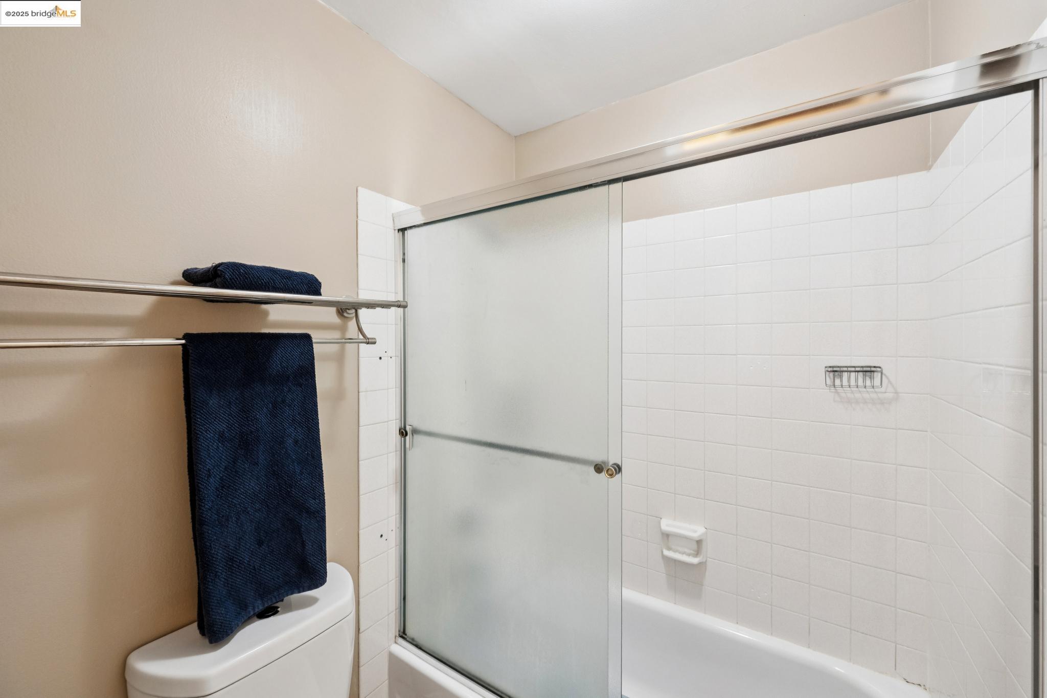 250 Whitmore Street Oakland, CA 94611 - Photo 27 of 33 Full bathroom featuring combined bath / shower with glass door and toilet