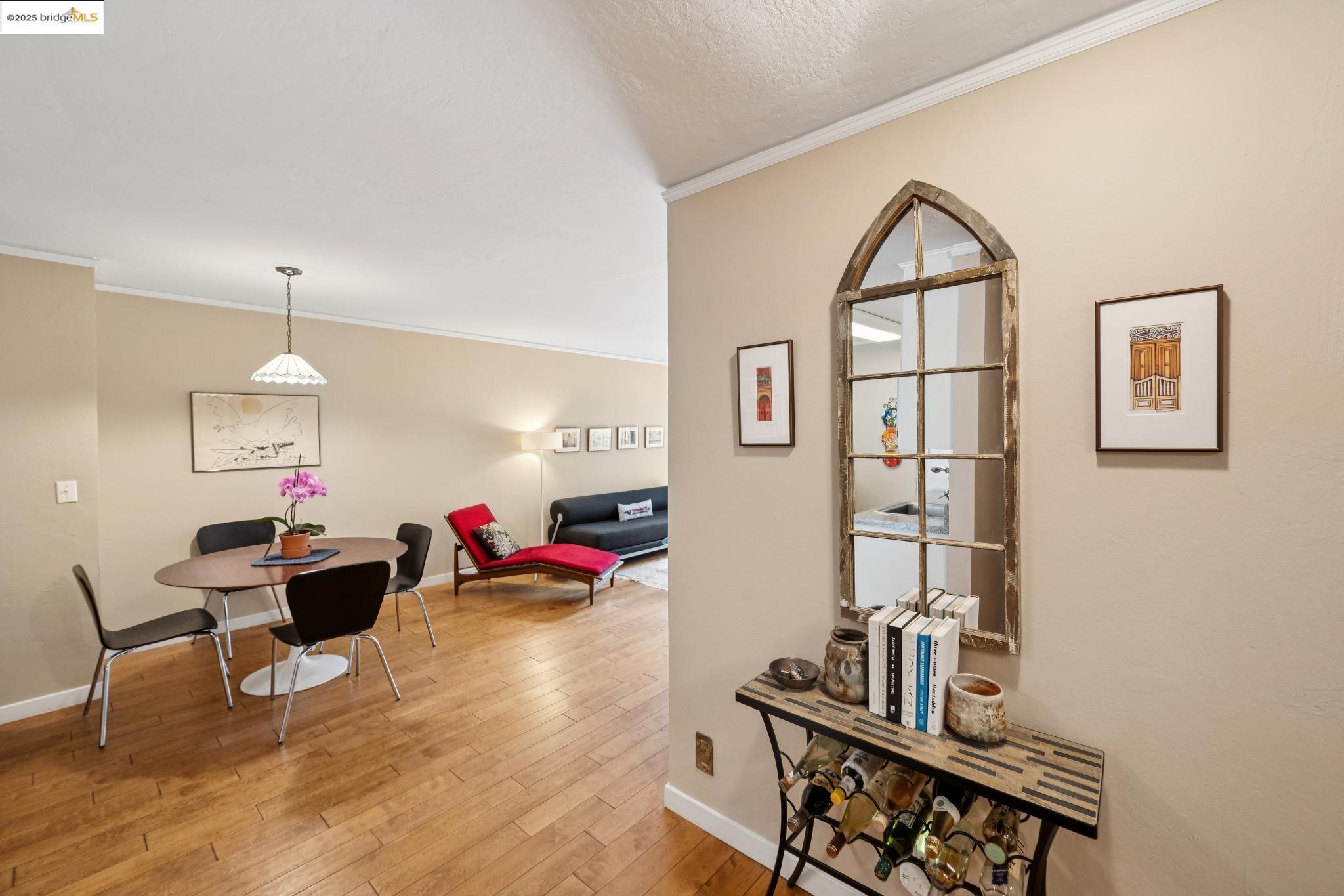 250 Whitmore Street Oakland, CA 94611 - Photo 4 of 33 Dining room with crown molding, light wood-style floors, and a textured ceiling