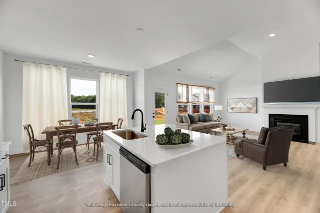 a kitchen with stainless steel appliances a refrigerator sink and cabinets