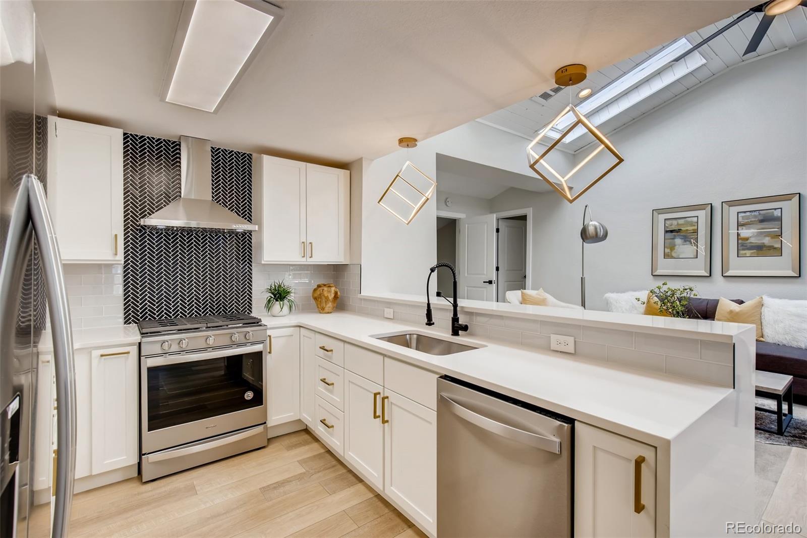 2925 Eaton Street Wheat Ridge, CO 80214 - Photo 11 of 30 a kitchen with a sink cabinets and appliances
