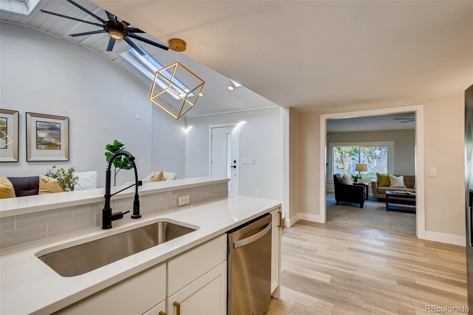 2925 Eaton Street Wheat Ridge, CO 80214 - Photo 12 of 30 a kitchen with a sink and a refrigerator
