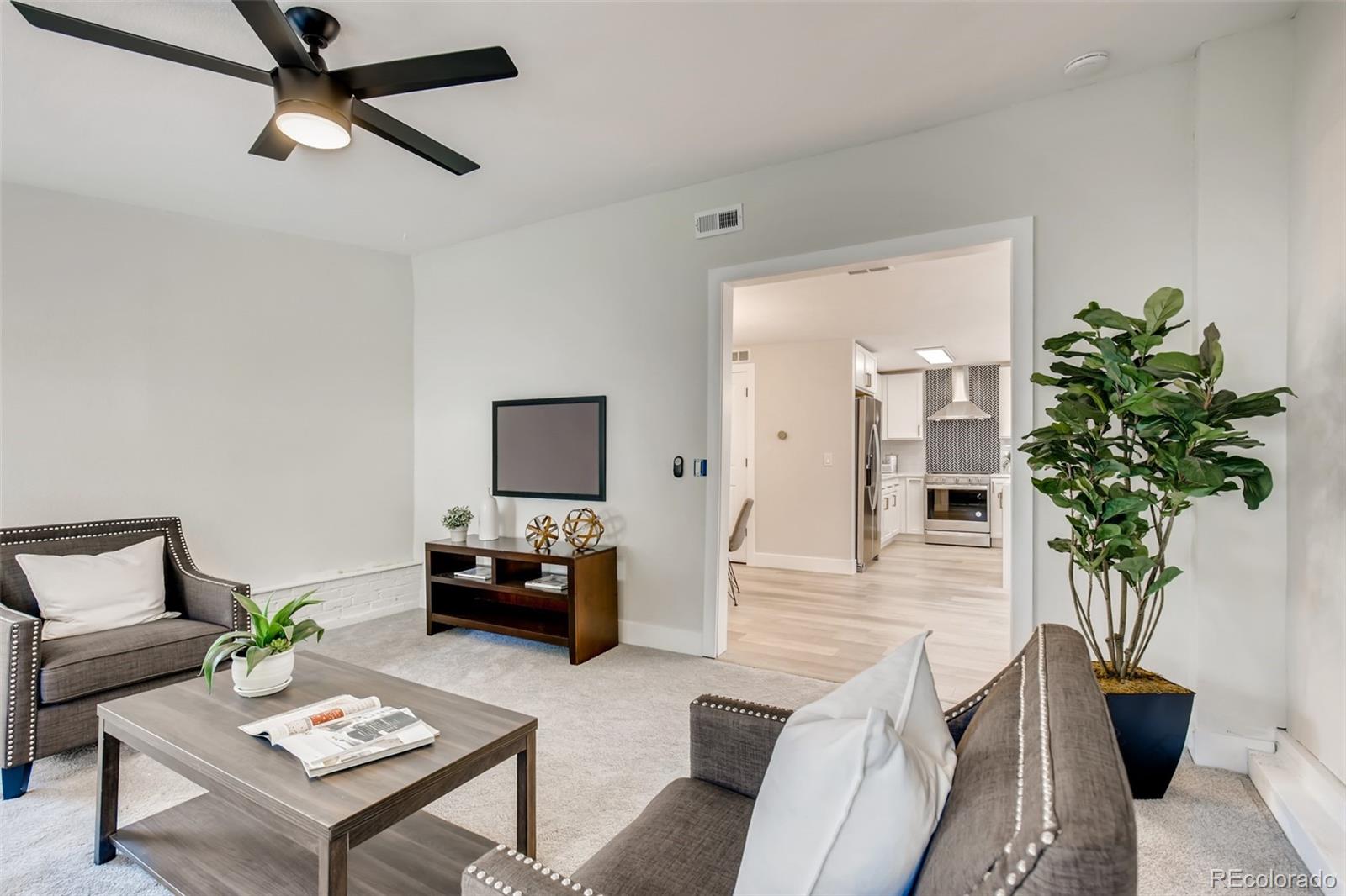 2925 Eaton Street Wheat Ridge, CO 80214 - Photo 14 of 30 a living room with furniture and a potted plant