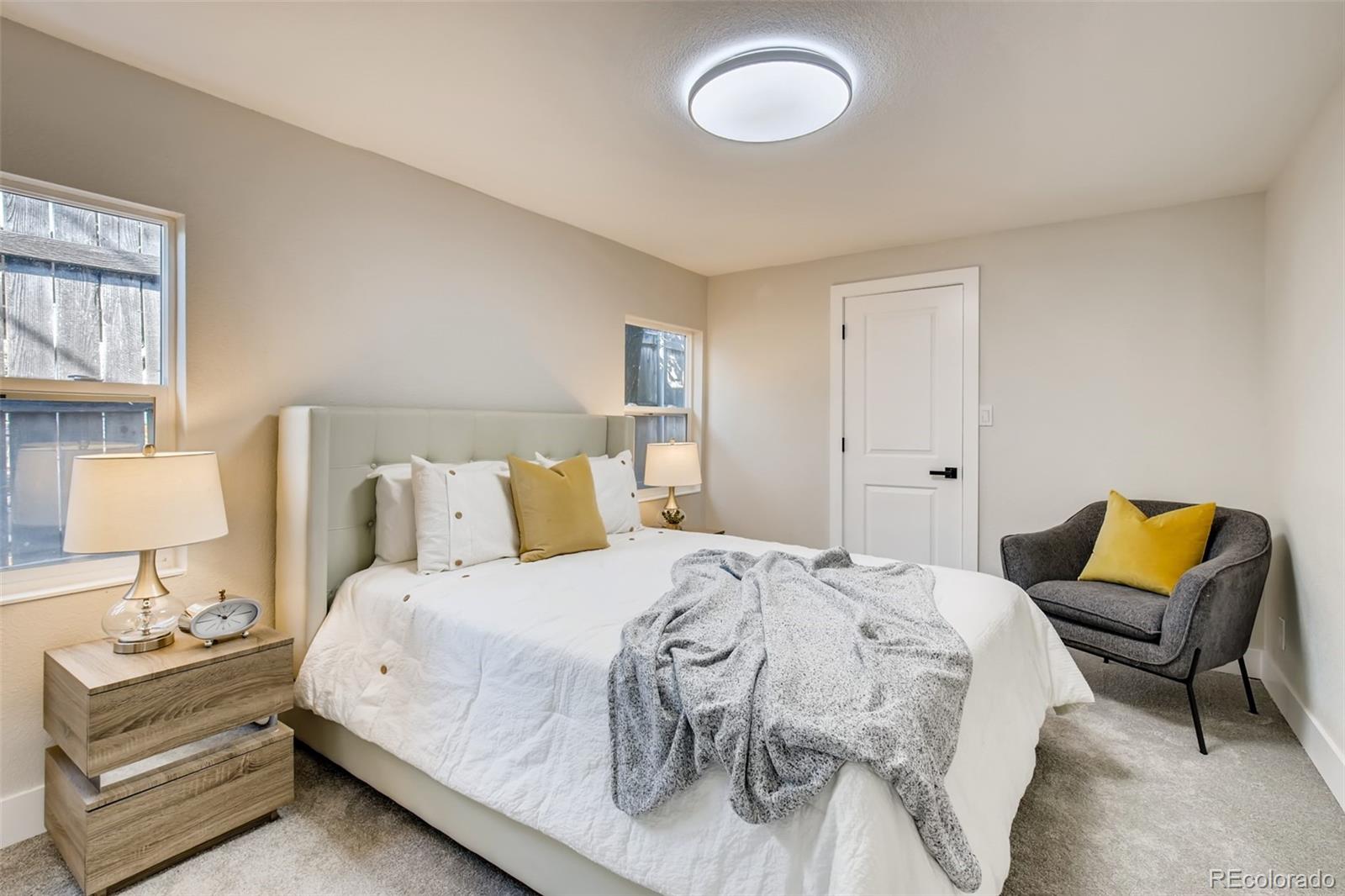 2925 Eaton Street Wheat Ridge, CO 80214 - Photo 16 of 30 a bedroom with a bed and lamp