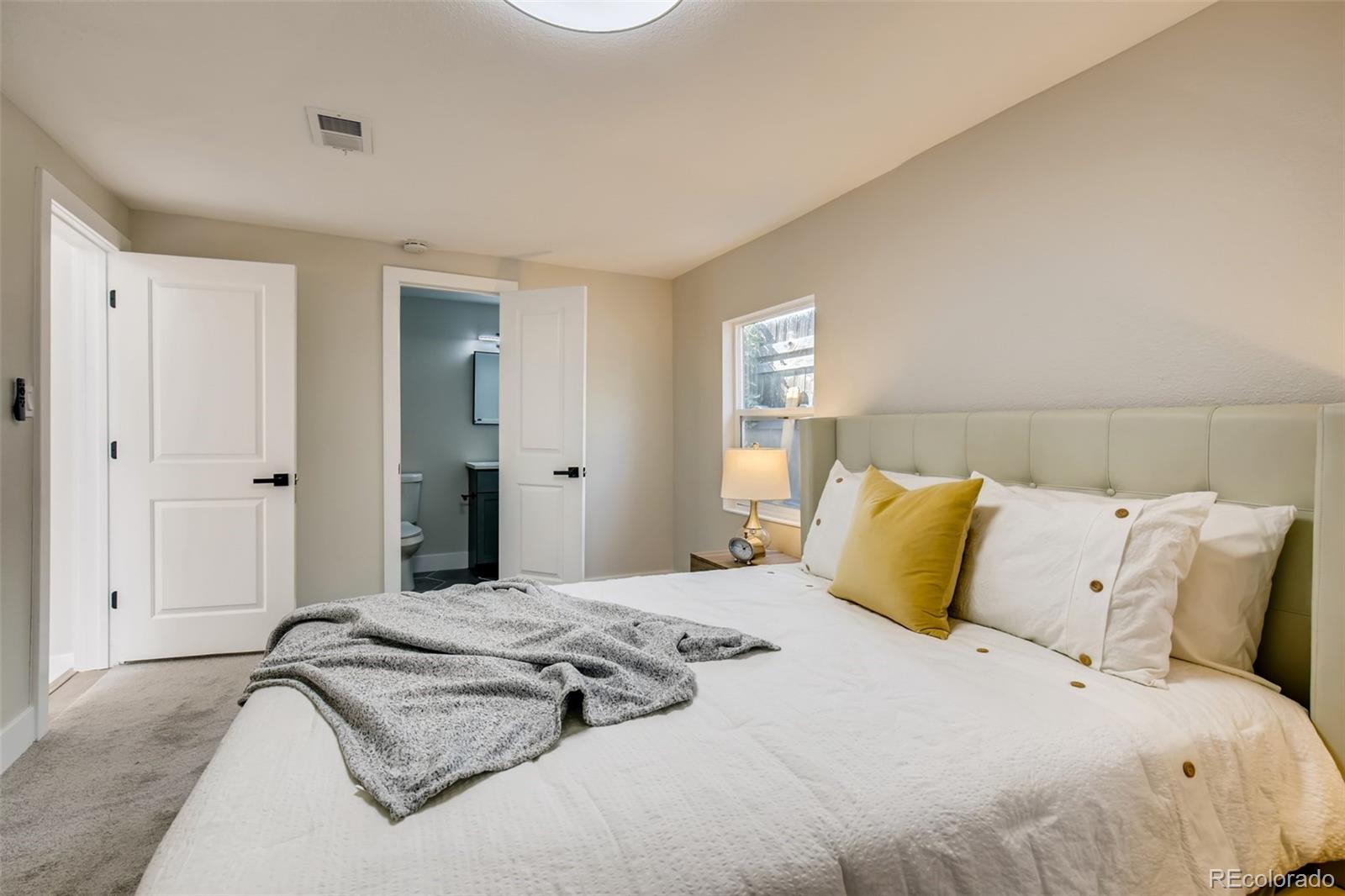 2925 Eaton Street Wheat Ridge, CO 80214 - Photo 17 of 30 a bedroom with a bed and a window