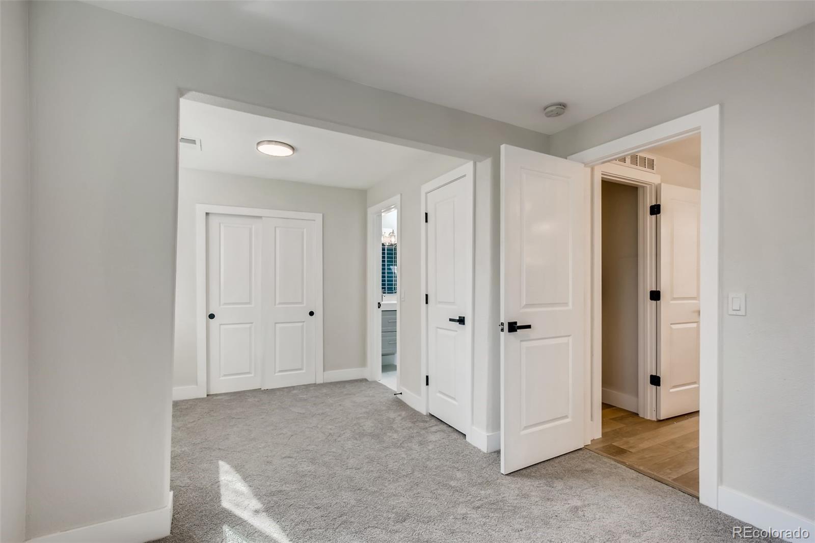 2925 Eaton Street Wheat Ridge, CO 80214 - Photo 22 of 30 a view of a bathroom with a hallway to other door