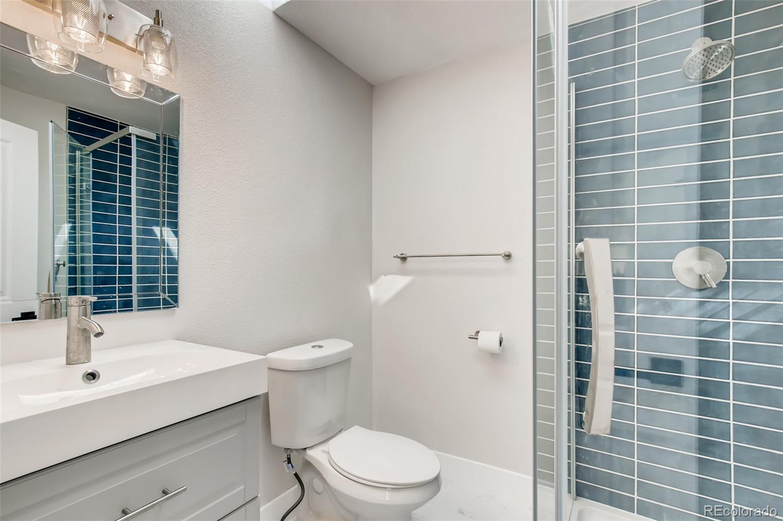 2925 Eaton Street Wheat Ridge, CO 80214 - Photo 26 of 30 a bathroom with a sink a toilet and shower