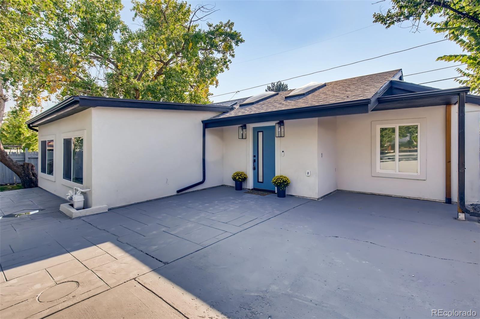 2925 Eaton Street Wheat Ridge, CO 80214 - Photo 3 of 30 a view of a house with a yard and garage